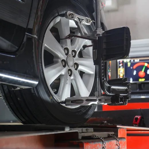 A vehicle on the alignment machine with the readout behind it